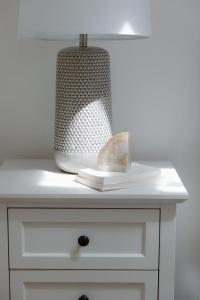a white cabinet with a lamp on top of it at 29 South by Mira-Mar in Wilmington