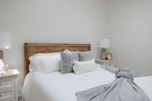 a white bedroom with a white bed with pillows at 29 South by Mira-Mar in Wilmington