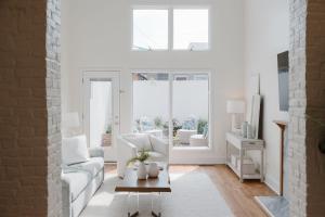 a living room with a white couch and a window at 29 South by Mira-Mar in Wilmington
