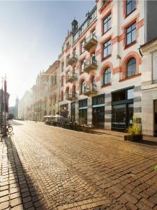 a cobblestone street in front of a building at Antique Apartments Plac Szczepański in Krakow