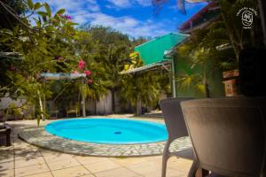 a swimming pool in the middle of a yard at Tropical Hostel in Pipa
