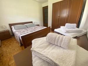 a bedroom with two beds with white towels on them at Maison Le Cré Appartamento 4 in Introd