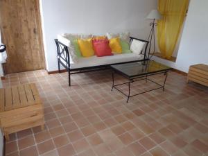 a living room with a couch with colorful pillows at Laborde in Mimbaste