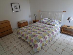 a bedroom with a bed with a colorful comforter at Laborde in Mimbaste