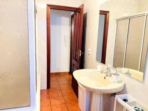 a bathroom with a sink and a mirror at La Casa de Carmen in Malpica