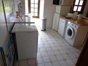 a kitchen with a sink and a washing machine at Laborde in Mimbaste