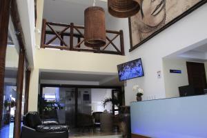 a living room with a lobby with a table at Sunbrazil Hotel - Antigo Hotel Terra Brasilis in Natal