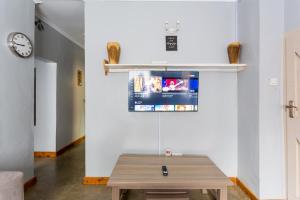 a table in a room with a tv on a wall at Yarkona Hedge in Nairobi