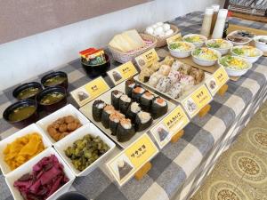 a table with different types of food on it at 釜石駅から徒歩5分ホテルマルエHotelMarue in Kamaishi