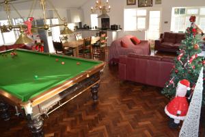 a living room with a pool table and a christmas tree at Family Retreat or Romantic Break 