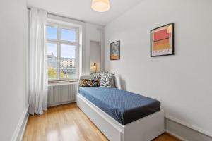 a bedroom with a bed and a window at NEU - Citywohnung mit Rheinblick in Basel