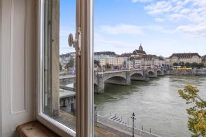 a window with a view of a river and a bridge at NEU - Citywohnung mit Rheinblick in Basel