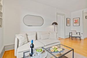 a living room with a white couch and a glass table at NEU - Citywohnung mit Rheinblick in Basel