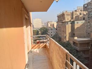 a balcony with a view of a city at شقة جديدة سوبر لوكس جامعة الدول المهندسين Egyptian Nile Cairo royal furnished apartment in muhandessin in Cairo