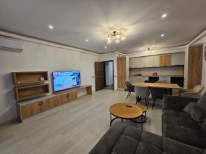 a living room with a couch and a table at ArtMob Apartment Isaran in Braşov