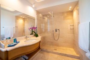 a bathroom with a sink and a shower at Hotel Grand Relais Dei Nuraghi in Baja Sardinia