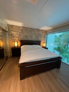 a bedroom with a bed with two lamps on the floor at Subic Sweet Escape by Bonnie in Olongapo