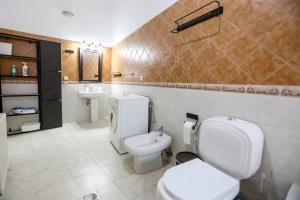 a bathroom with a toilet and a bidet and a sink at Lovely Loft City Center Korca #8 in Korçë