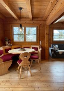 ein Zimmer mit einem Tisch und Stühlen in einer Hütte in der Unterkunft Chalet Kleinbergsonne in Filzmoos