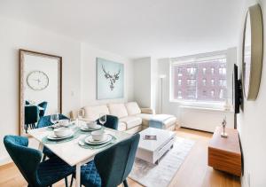 Stunning 2 BED 2 BA At UES في نيويورك: غرفة معيشة مع طاولة وأريكة