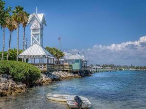 a boat in the water next to a clock tower at Golf Coast Charmer in Bradenton