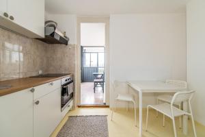 a kitchen with a table and a table and chairs at 7 Heaven in Belgrade