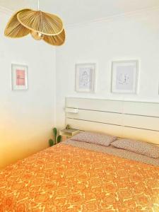 a bedroom with a bed and two pictures on the wall at Nice View Apartment in the city center in Fuzeta