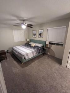 a bedroom with a bed and a ceiling fan at 2 Bed 2 Bath with pool and spa in Phoenix