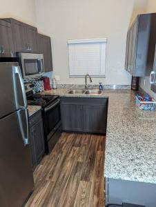 a kitchen with a sink and a refrigerator at 2 Bed 2 Bath with pool and spa in Phoenix