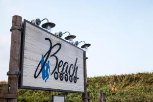 a sign for a beach with lights on it at Beach Motel St. Peter-Ording in Böhl +188 photos