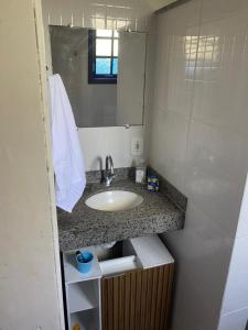 a bathroom with a sink and a mirror at Chácara De Paula in Vassouras