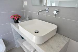 a bathroom with a white sink on a counter at Altamarea Beach Experience Villetta SA in Marina di Pescoluse