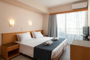 a hotel room with a bed with towels on it at Nafsika Hotel in Rhodes Town