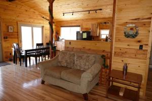 a living room with a couch and a dining room at Mountain Escape @ Deep Creek Lake in Oakland