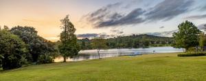 a view of a lake with a boat in the water at African Sky Hotels - Pine Lake Inn in White River