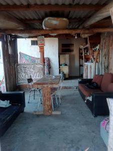 sala de estar con mesa y sofá en Vida Playera en Punta Del Diablo