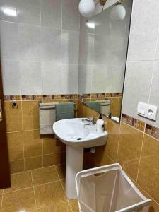 a bathroom with a sink and a mirror at Apartamento con vistas a la montaña in Infiesto