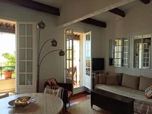 a living room with a couch and a table at Mas Flora in La Croix-Valmer