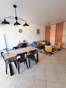 a living room with a table and a couch at La maison des amis in Ondres