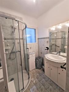 a bathroom with a shower and a sink at La maison des amis in Ondres