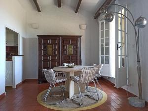 a dining room with a table and two chairs at Mas Flora in La Croix-Valmer
