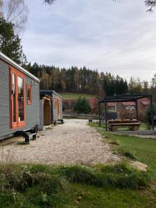 a campsite with a tent and a picnic table at Maringotky Šumava in Sušice