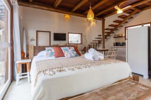 En eller flere senge i et værelse på Casa da Vila Escondida em Pipa por Carpediem