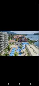 an aerial view of a resort with a pool at Apartamento no Hotel Porto Marina Mangaratiba in Mangaratiba