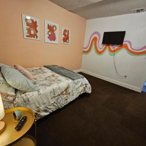 a bedroom with a bed and a tv on the wall at Comfortable in a 2 bed 2 bath in Lakeland