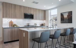 a kitchen with a large island with blue bar stools at Level Hollywood in Los Angeles