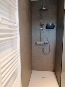 a shower with a shower head in a bathroom at modern cosy luxury apartement in Antwerp