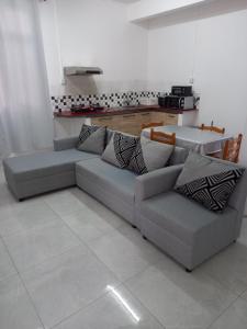 a living room with two couches and a kitchen at Boisbleu villa in Flic-en-Flac