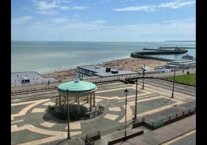 a view of a beach with a gazebo and the ocean at Beach View Apartment - Top floor sea view Ramsgate in Ramsgate