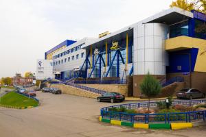 a large building with cars parked in a parking lot at Alexandrovsky Garden in Nizhny Novgorod